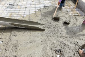 Beaverton concrete foundation worker spreading concrete floor